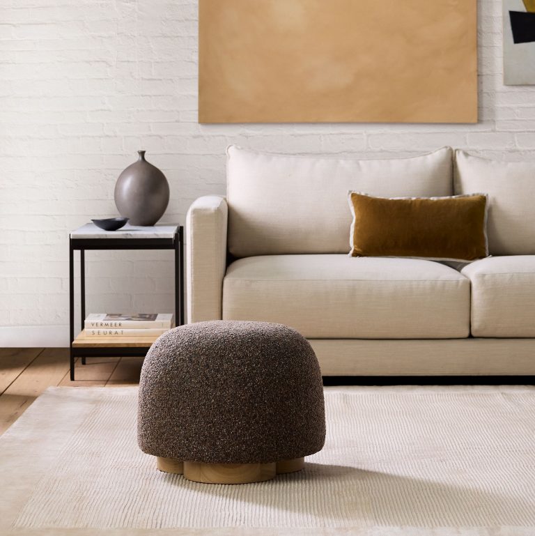 a cute ottoman to add a cozy, inviting touch to the living space